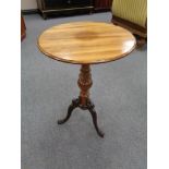 An antique mahogany wine table on cast iron legs