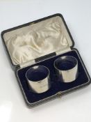 A pair of boxed silver serviette rings,