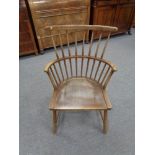 A twentieth century oak stick backed armchair