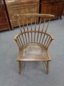A twentieth century oak stick backed armchair