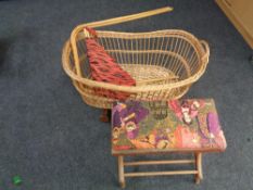 A wicker moses basket on wheels together with a bentwood stool