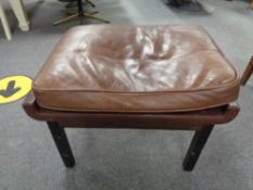 A mid century footstool upholstered in brown leather