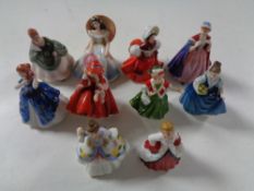 Ten miniature Royal Doulton lady figures.