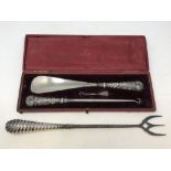 A Victorian cased silver mounted shoehorn and button hooks,