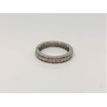 A white gold diamond half eternity ring, approximately 0.