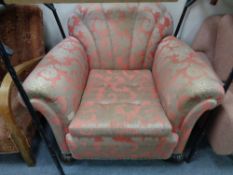 An Art Deco style armchair in salmon and golden coloured fabric