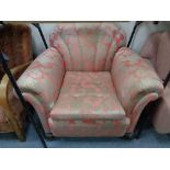 An Art Deco style armchair in salmon and golden coloured fabric