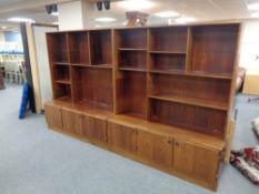 A mid century Danish twin sectioned bookcase fitted with cupboards beneath