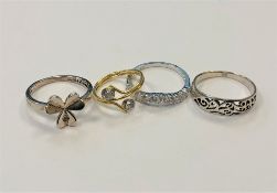 Four white metal dress rings