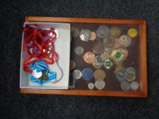 A box and counter display cabinet containing running and cycling medals