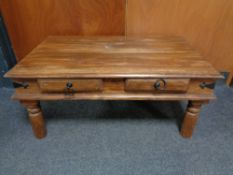 A Sheesham wood coffee table fitted with two drawers