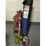 A box of rock climbing equipment, boots, helmet, ropes, axe,