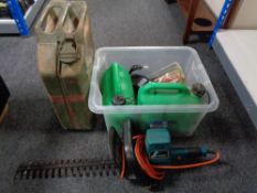 A box of Black and Decker hedge trimmer, two fuel cans,