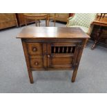 A Georgian style oak cabinet fitted two drawers