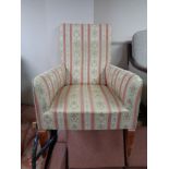 A fireside chair in Regency striped fabric