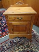 A pine bedside cabinet fitted with a drawer