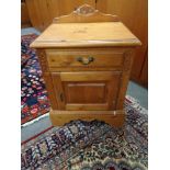 A pine bedside cabinet fitted with a drawer