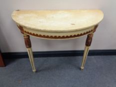 A white and gilt demi lune hall table on reeded legs