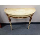 A white and gilt demi lune hall table on reeded legs