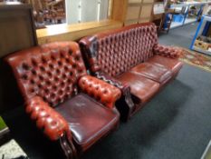 A red buttoned leather Chesterfield three seater settee with matching armchair