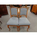 A pair of early twentieth century oak framed dining chairs