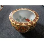 A glazed pottery fish bowl planter