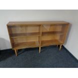 A mid century teak four drawer sliding glass door bookcase