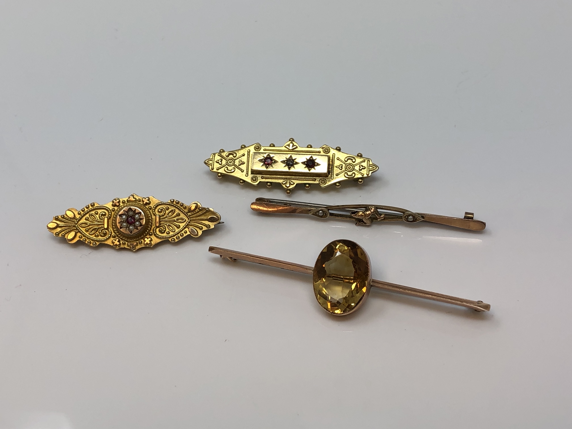 Four 9ct gold brooches, one set with ruby and diamond CONDITION REPORT: 11.