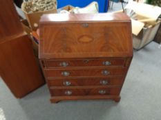 A mahogany Regency style bureau fitted with four drawers