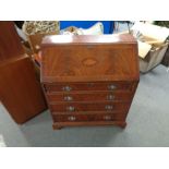 A mahogany Regency style bureau fitted with four drawers