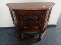 An Old Charm cabinet on raised legs