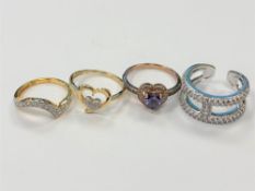 Four white metal dress rings