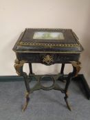 An unusual 19th century ebonised Empire style table with ormolu mounts and gallery,