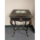 An unusual 19th century ebonised Empire style table with ormolu mounts and gallery,