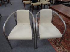 A set of four tubular metal plastic seated armchairs