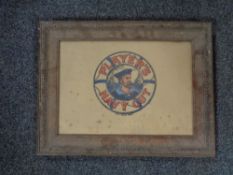 An Edwardian oak framed Player's Navy Cut advertisement on card