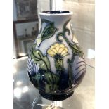 A Moorcroft vase, yellow flowers on blue ground, height 13.5 cm, signed to base.