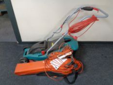 A Flymo garden vacuum together with a Bosch electric lawn mower with lead