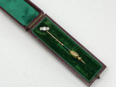 A nice quality gold three stone diamond pin