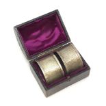 A boxed pair of silver serviette rings,