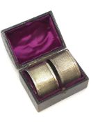A boxed pair of silver serviette rings,
