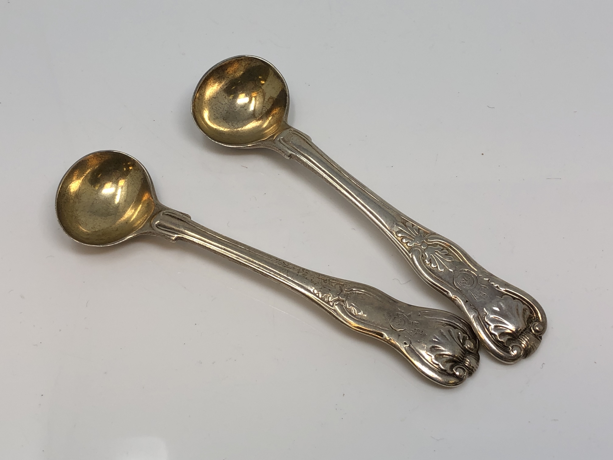 A pair of silver gilt Georgian salt spoons marked for the 98th Regiment CONDITION REPORT: