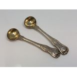 A pair of silver gilt Georgian salt spoons marked for the 98th Regiment CONDITION REPORT: