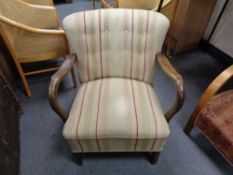 A twentieth century wooden framed armchair upholstered in striped fabric