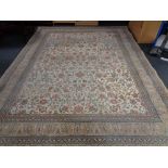 A machine made Persian design woolen carpet on cream ground, 404cm by 301cm.