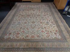 A machine made Persian design woolen carpet on cream ground, 404cm by 301cm.