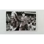 FOOTBALL, signed photo by Tommy Docherty, half-length celebrating with Manchester United players