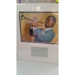 POP MUSIC, signed album page by Louis Armstrong, overmounted beneath photo playing trumpet, 14.5 x