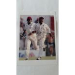 CRICKET, signed colour photo by Brian Lara, full-length celebrating running off pitch after