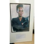 CINEMA, James Bond, signed album page by Grace Jones, overmounted beneath colour photo in half-